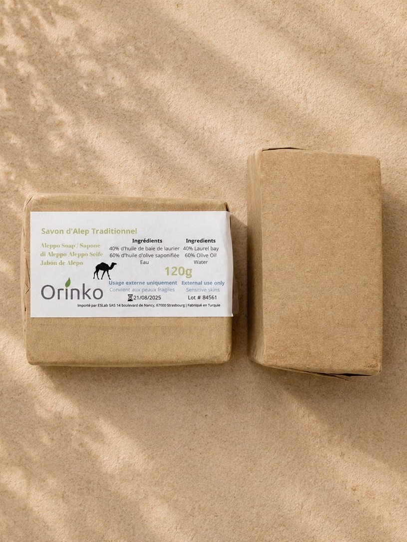 A custom-branded Aleppo soap with a printed kraft wrapper and label, ready for a retailer's own brand