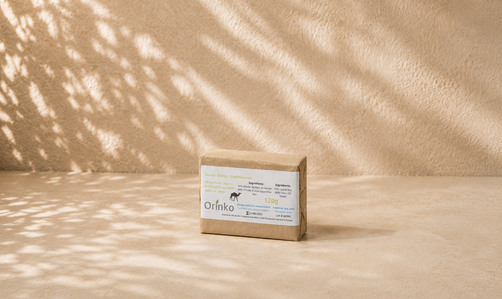 A single Aleppo soap bar wrapped in thin kraft paper with a label, ready for retail